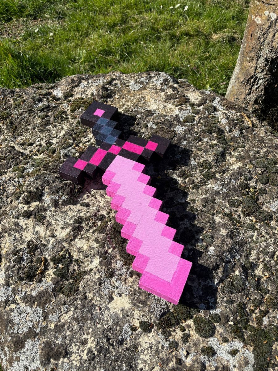 Pixel sword flat on stone